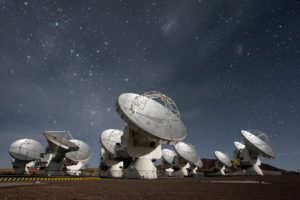Radio telescopes pointed up at the night sky