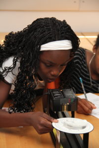A young girl participates in hands-on astronomy lesson.