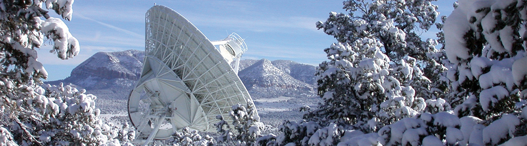 VLBA Antenna durrounded by snowy trees