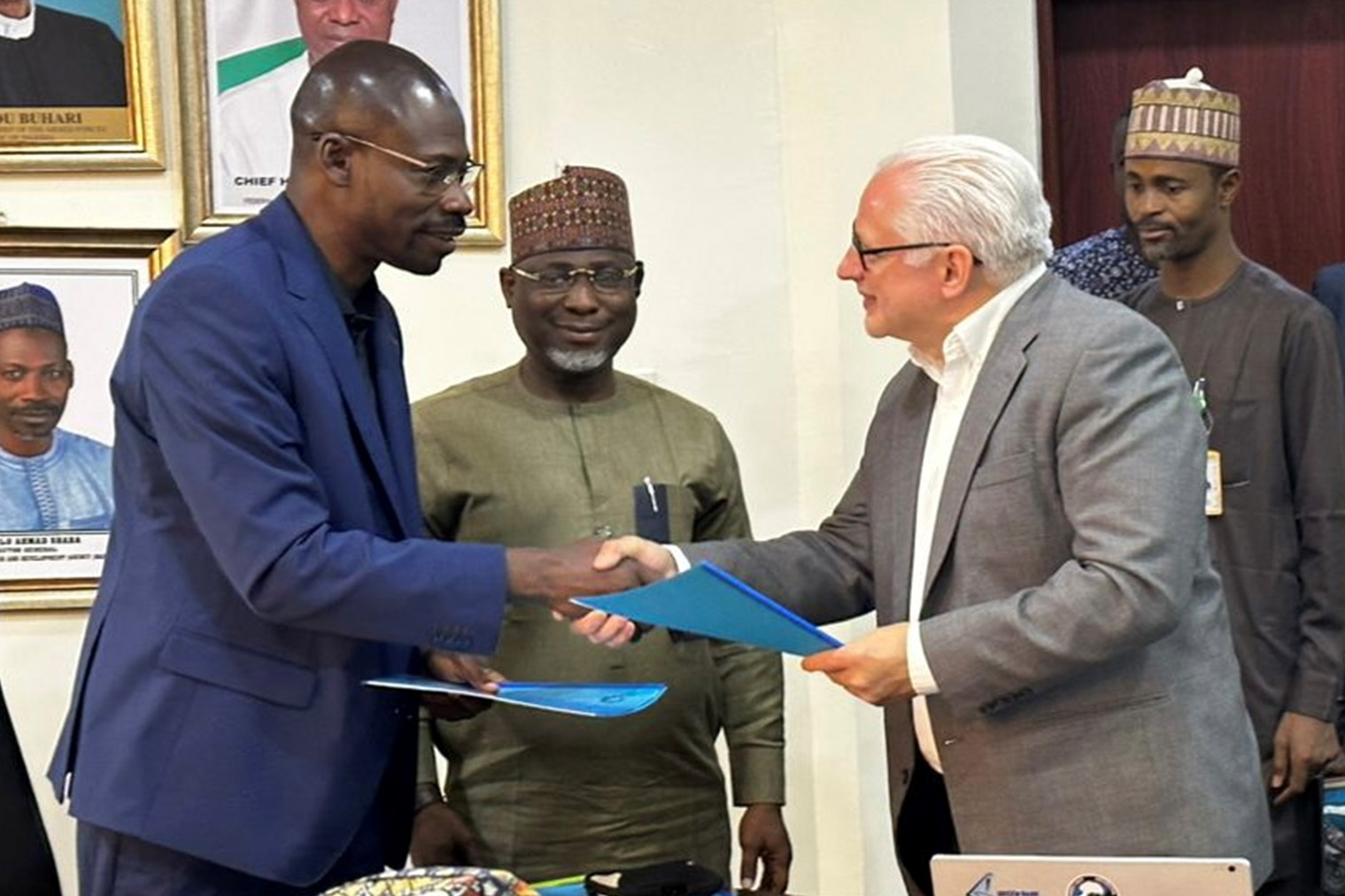 Tim Spuck shakes hands with Ahmed Halilu Shabar at signing of MoU with the Nigerian National Space Research and Development Agency
