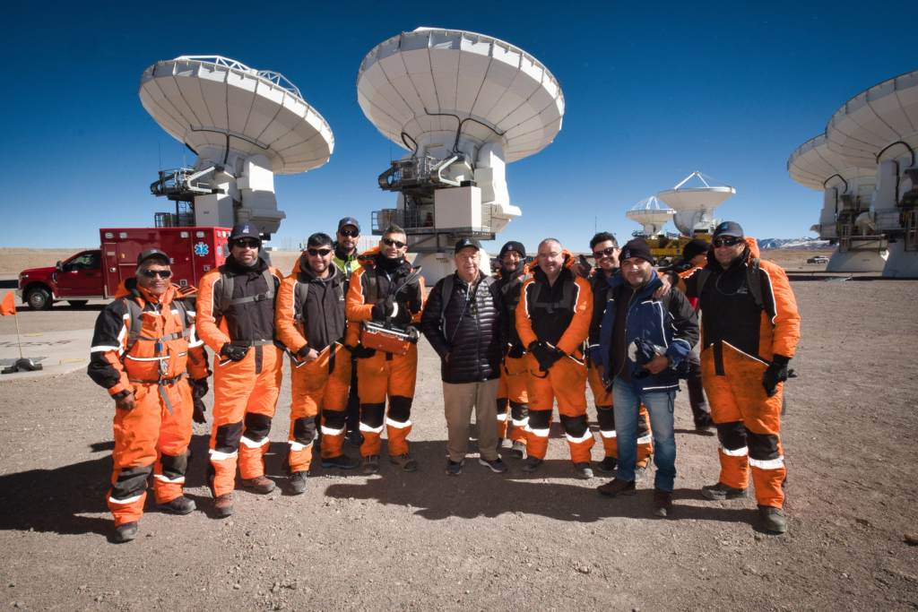 ALMA staff with UN Secretary-General António Guterres in front of ALMA antennas at the high site.