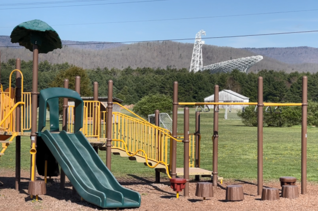 School playground with Green Bank Telescope in the background.
