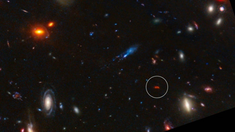 James Webb Space Telescope deep field image with highlighted distant red galaxy
