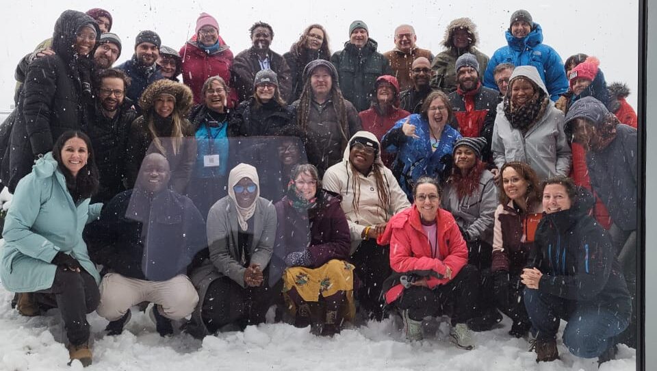 Anica Miller-Rushing smiles with a group of ASTRO ACCEL members in the snow